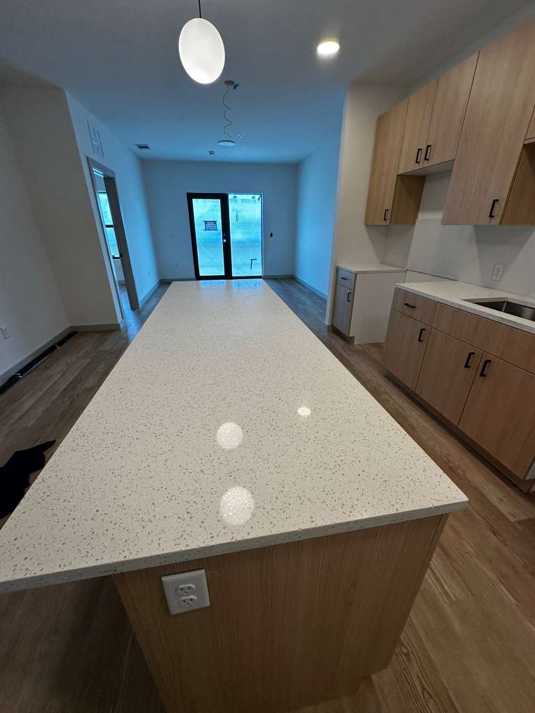 Sparkling clean modern kitchen with quartz island cleaned by Stellar Cleaning Services SWFL